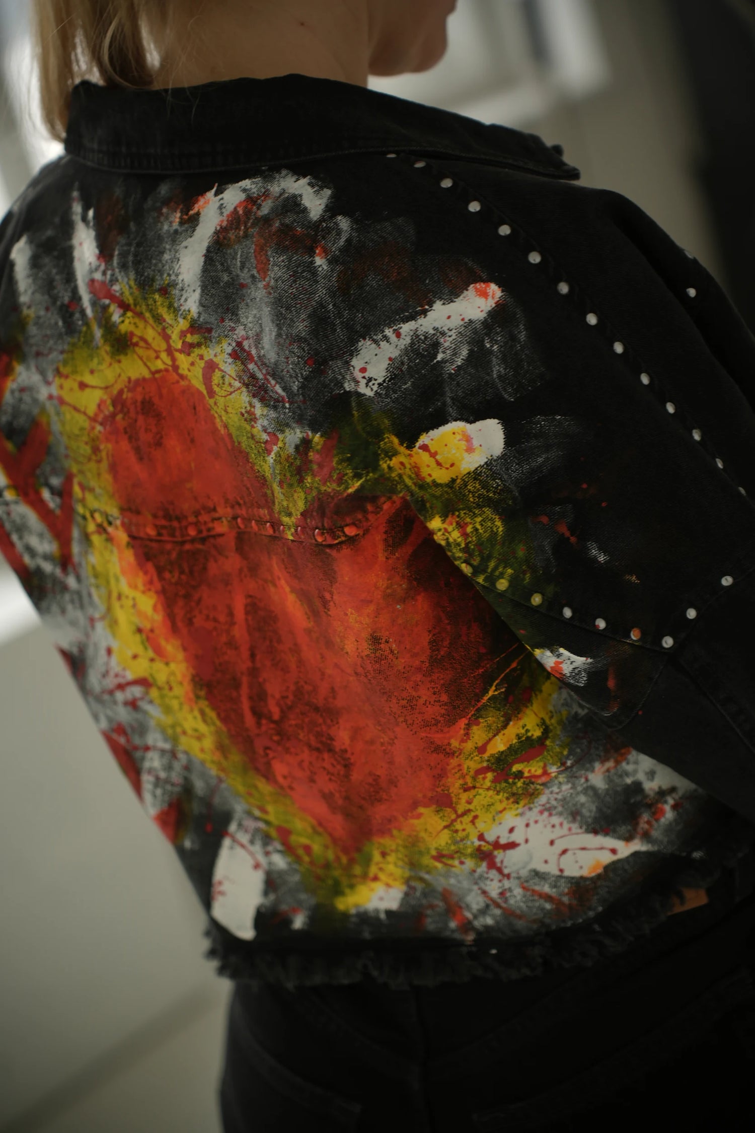 Colorful tie-dye jacket with abstract patterns on a blurred background